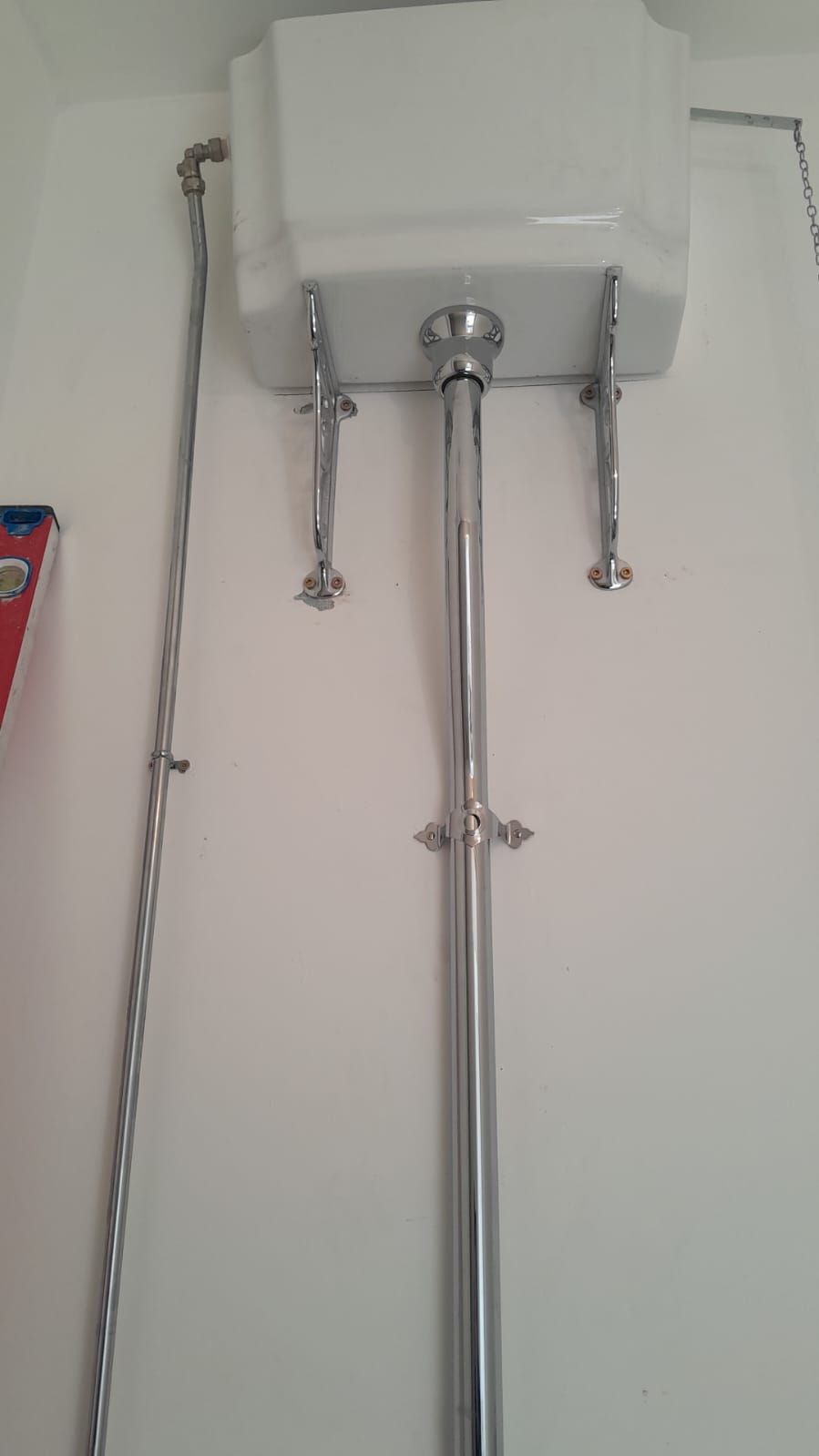 Traditional high-level cistern with chrome flush pipe