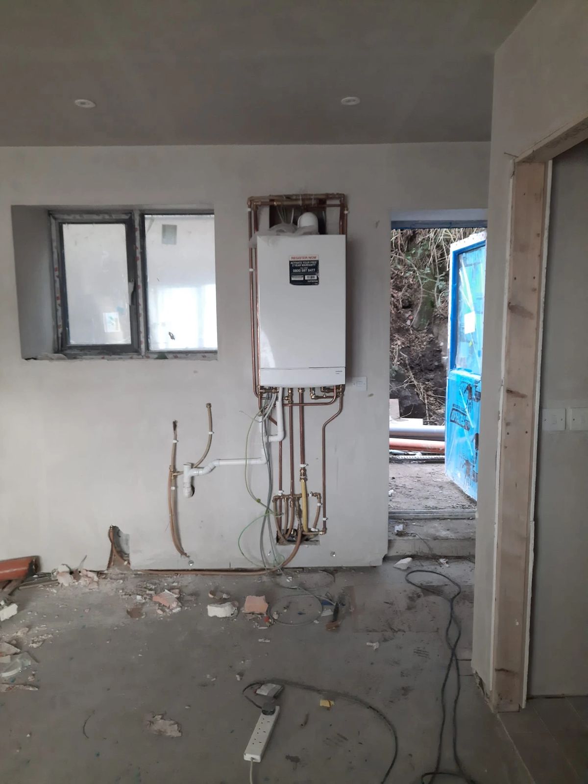 New boiler fitted on the wall of a new-build house