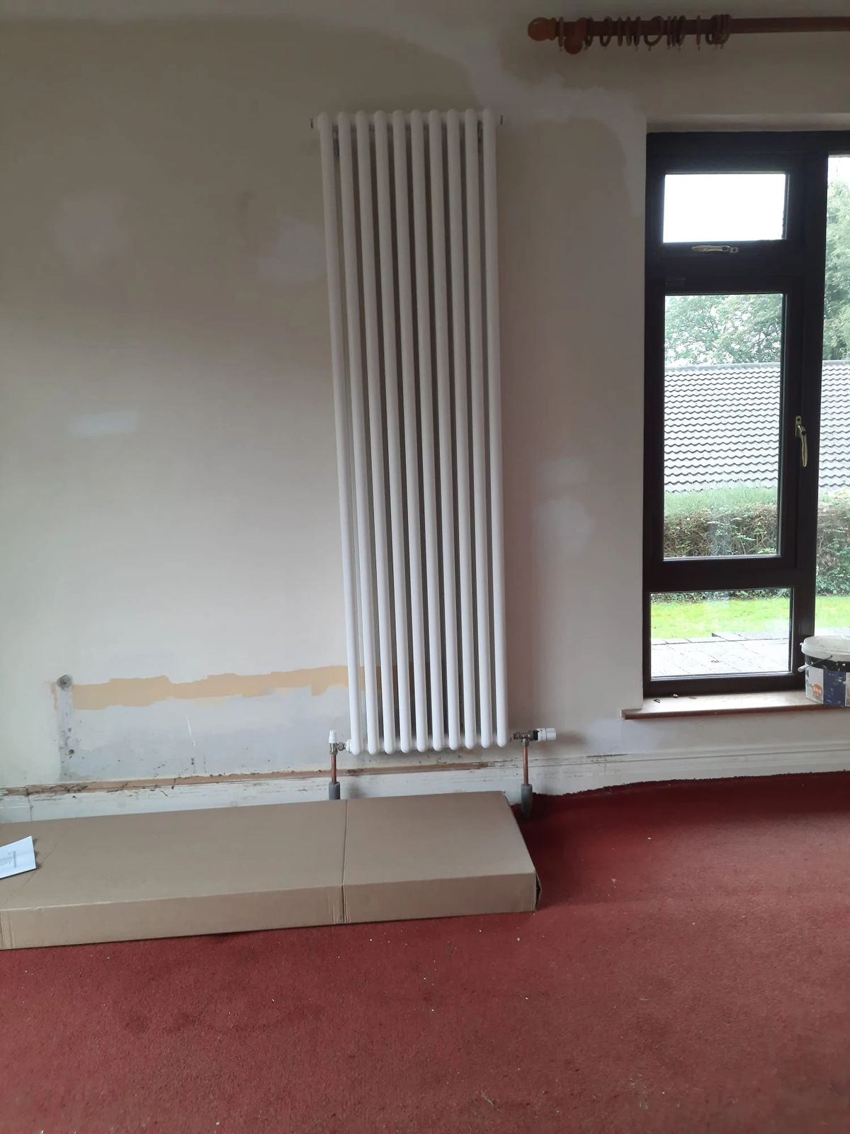 New white column radiator on a wall